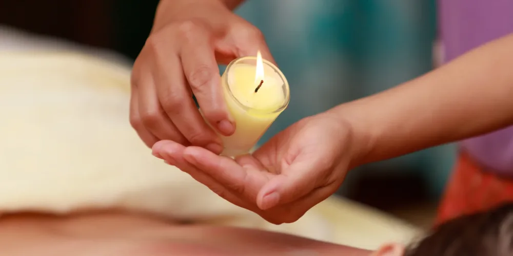 Asian woman enjoying a salt scrub massage at spa.