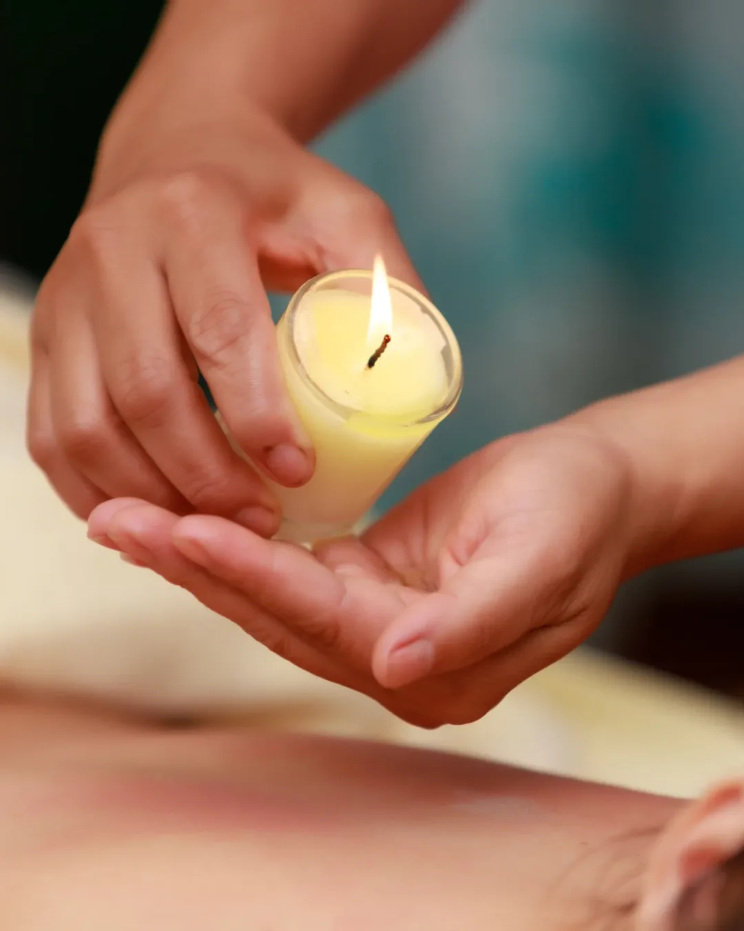 Asian woman enjoying a salt scrub massage at spa.